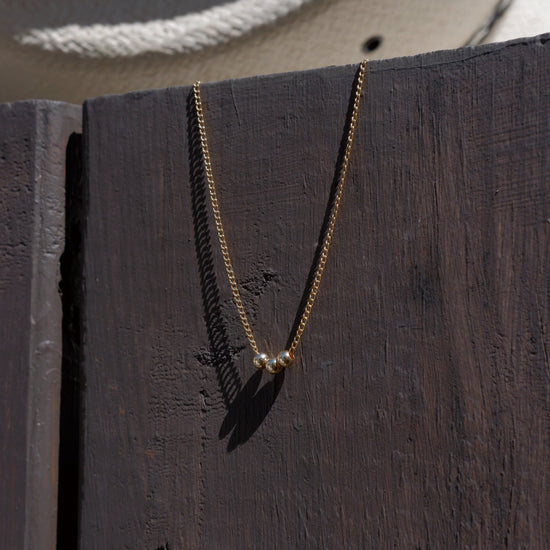 Necklace with a pendant hanging on a wooden surface