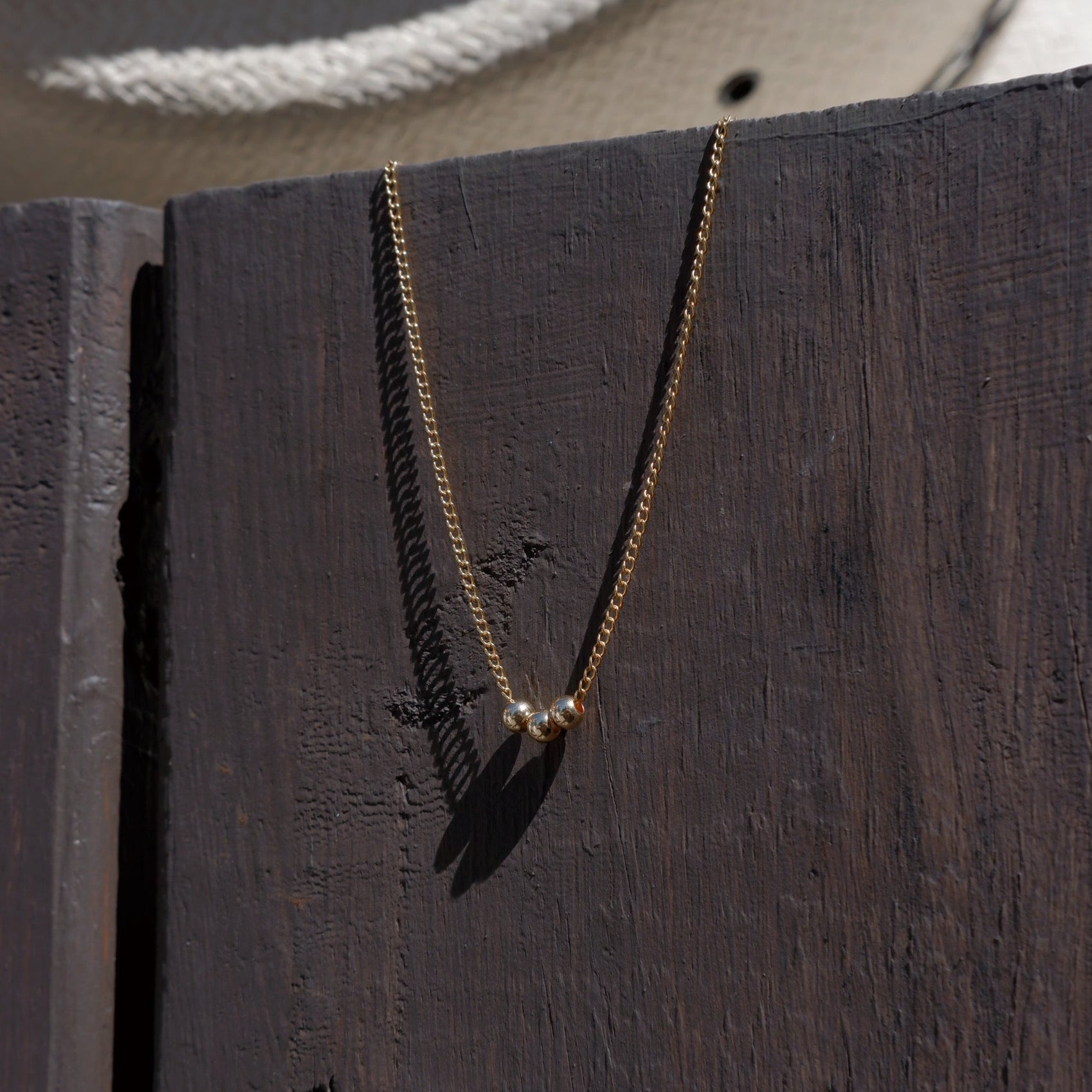 Necklace with a pendant hanging on a wooden surface