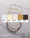 Three layered bracelets with color swatches labeled Pantone on a marble background