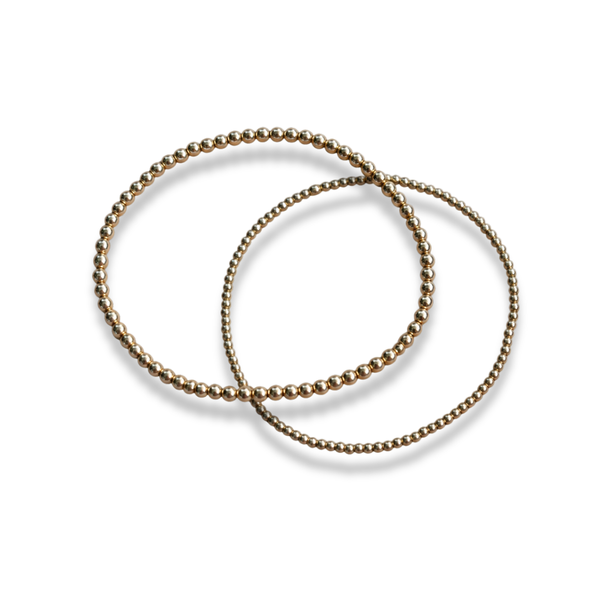 Interlocking 14k gold-filled beaded stacking bracelets shown together on a light background