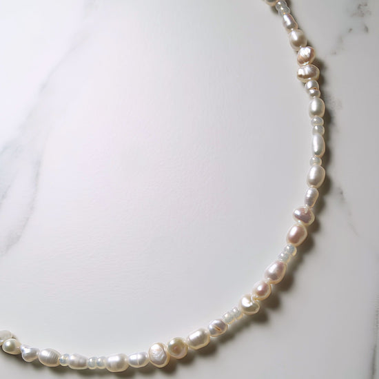 Pearl necklace on a marble surface