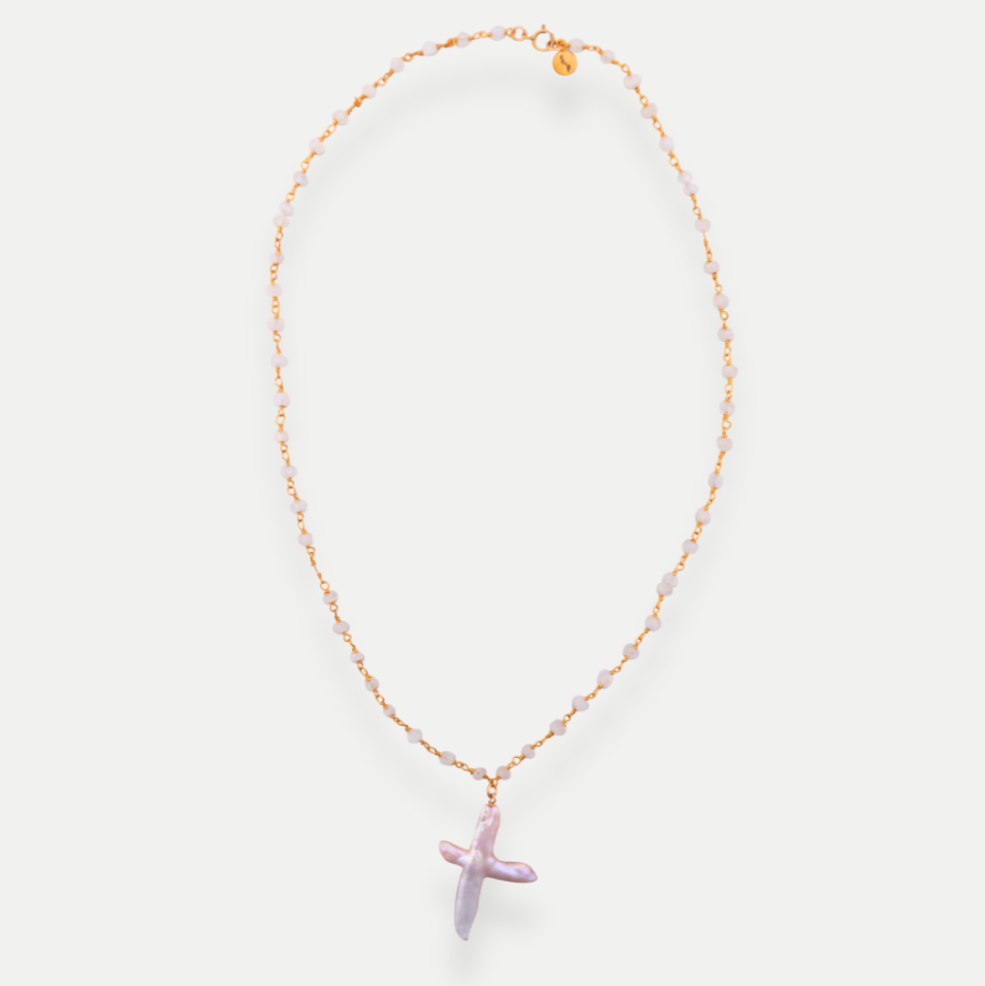 Necklace with a purple cross pendant on a white background