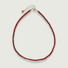 Red carnelian necklace on a light gray background