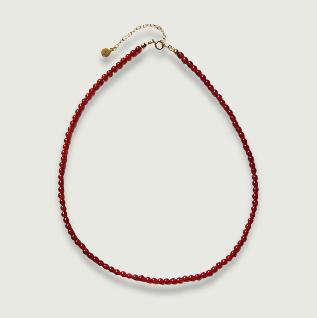 Red carnelian necklace on a light gray background
