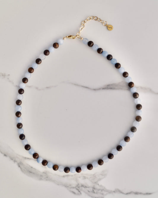 Aquamarine and Bronzite Beaded Necklace with 14k gold-filled clasp and extender, flat on marble