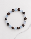 Aquamarine and Bronzite Beaded Bracelet in sterling silver, laid flat on white marble