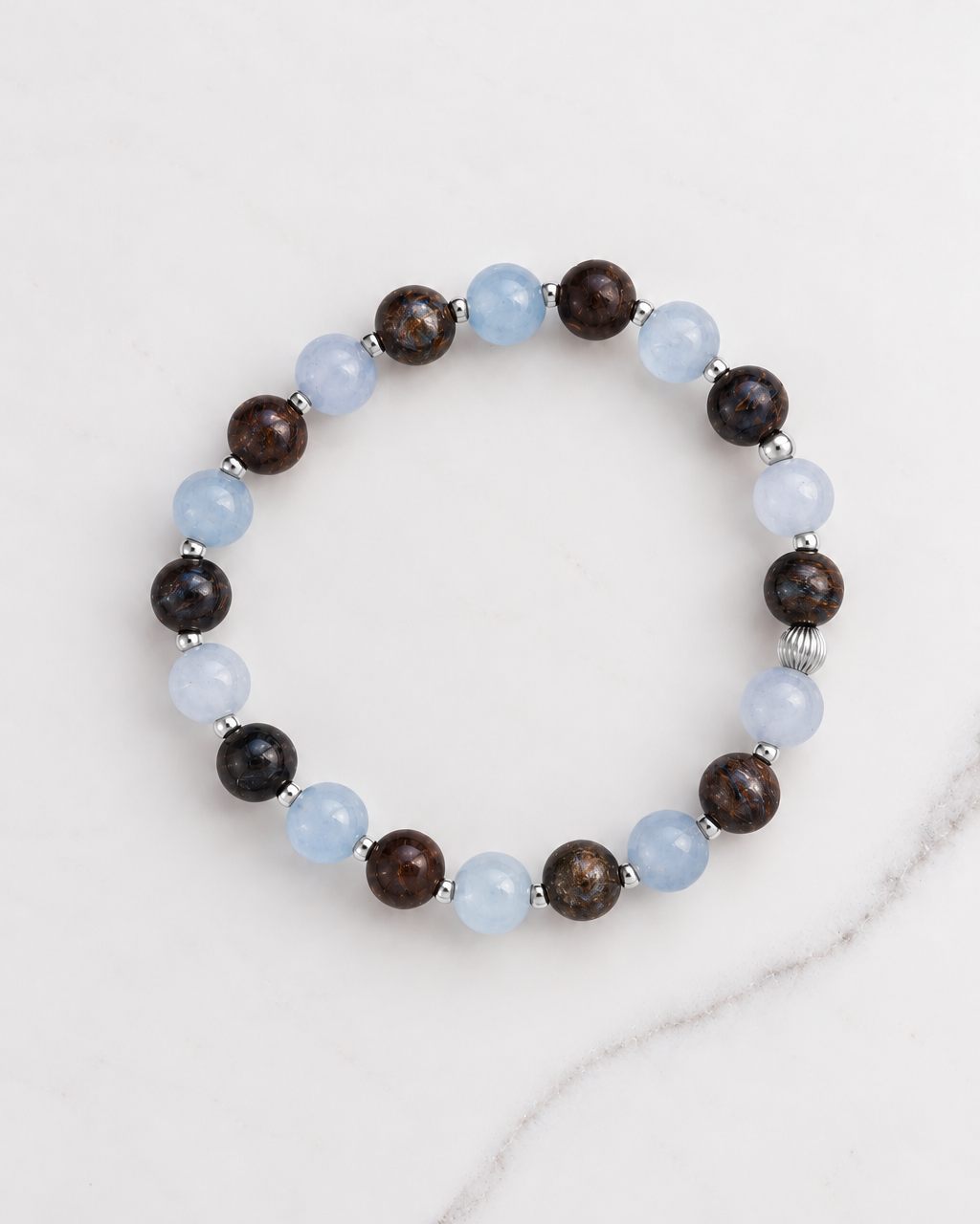 Aquamarine and Bronzite Beaded Bracelet in sterling silver, laid flat on white marble